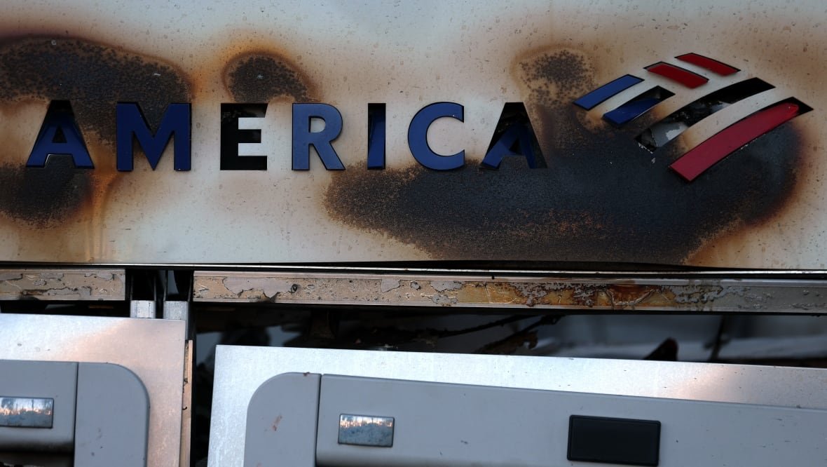 A bank machine is destroyed by fire.