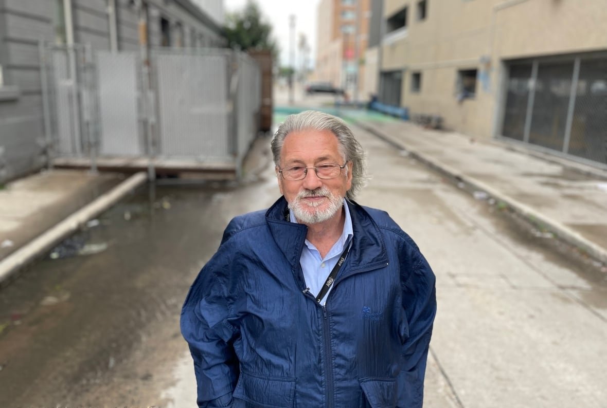 A man stands on a road.