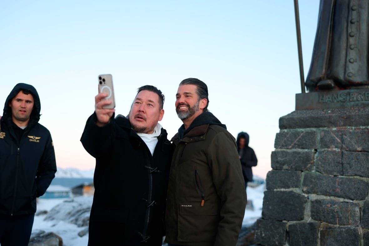 Two people pose for a selfie outside during winter.