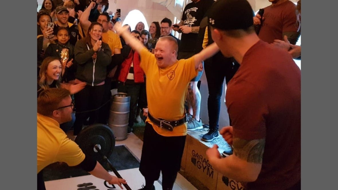 austin-clapp-4 An individual with Down Syndrome in front a cheering crowd.