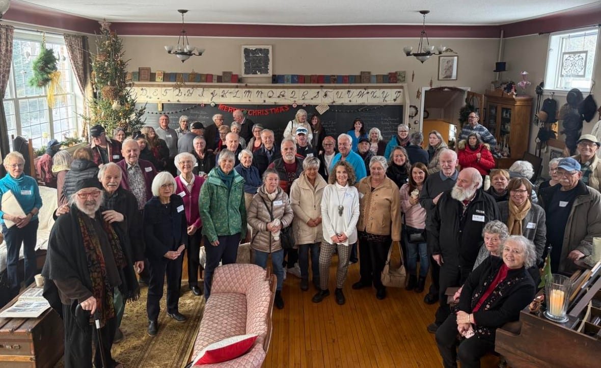 A group of elderly people smiling for a photo