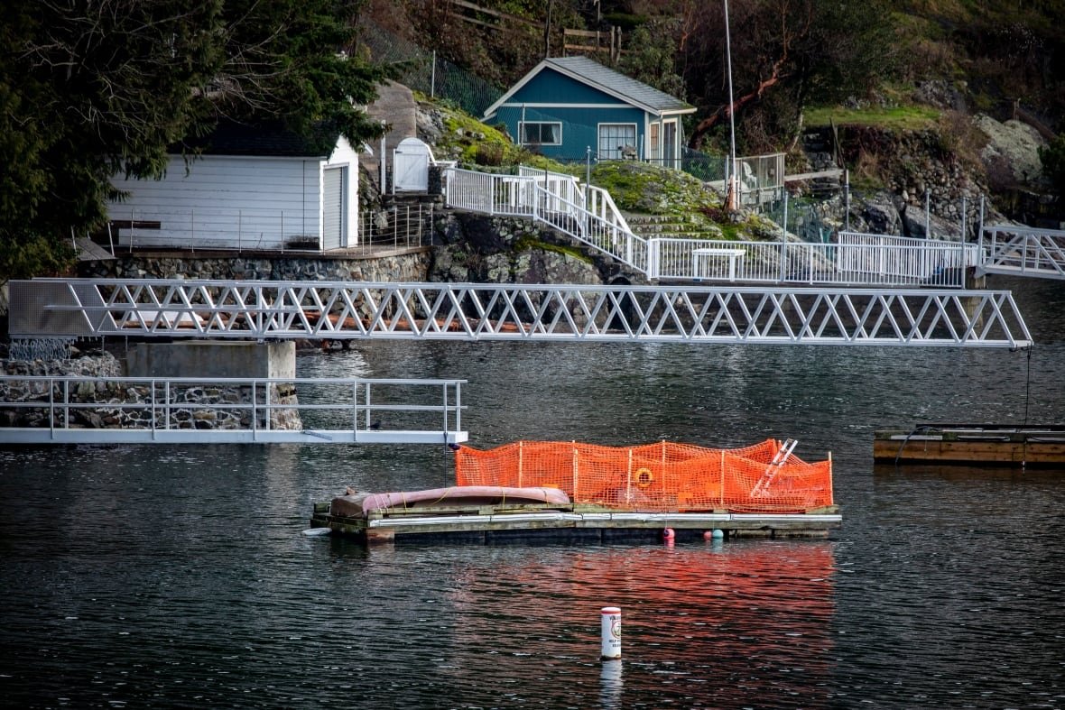 bowen-island-2 A dock wrapped in orange industrial fencing to keep sea lions away.