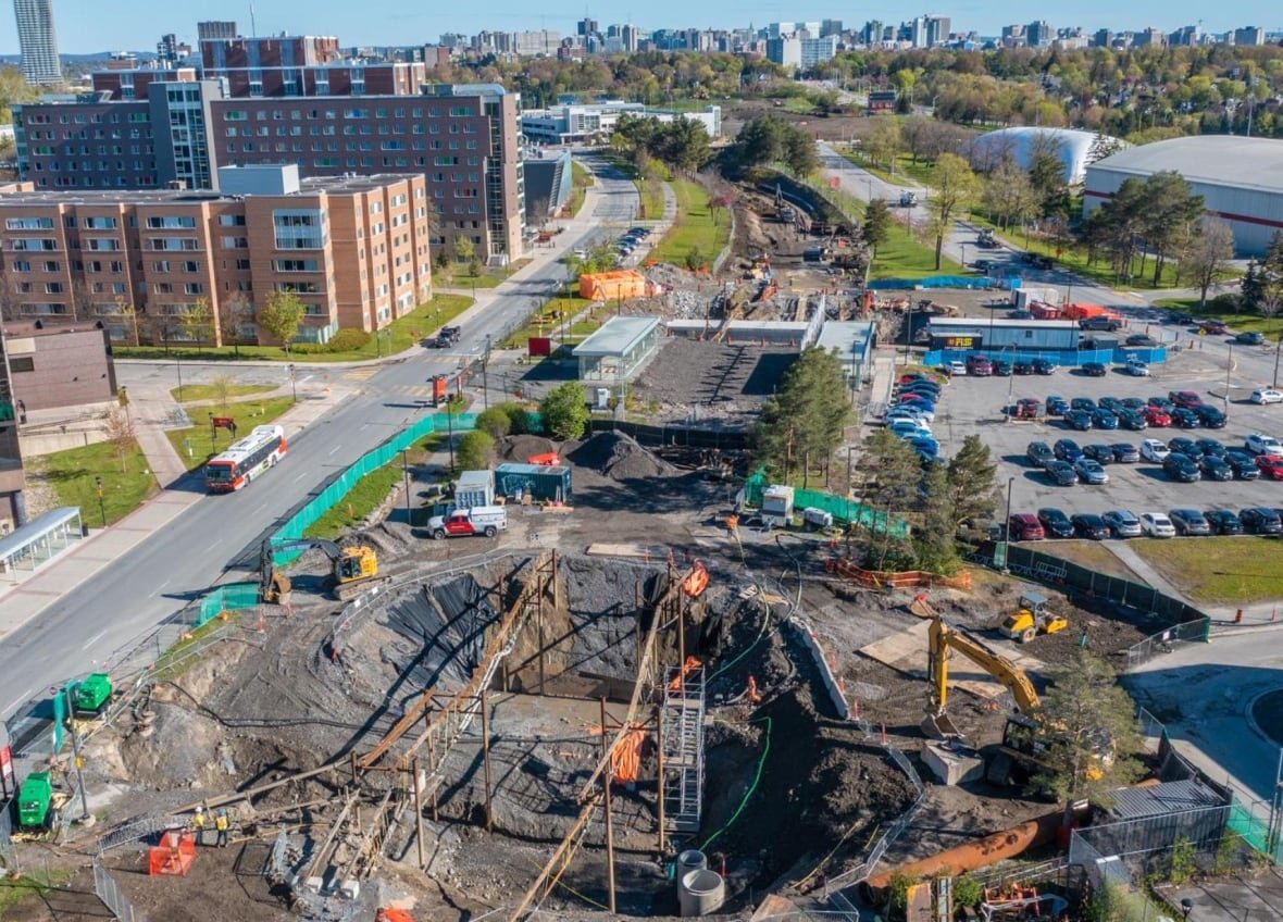 carleton-university-trillium-line-may-city-powerpoint A hole with orange construction materials