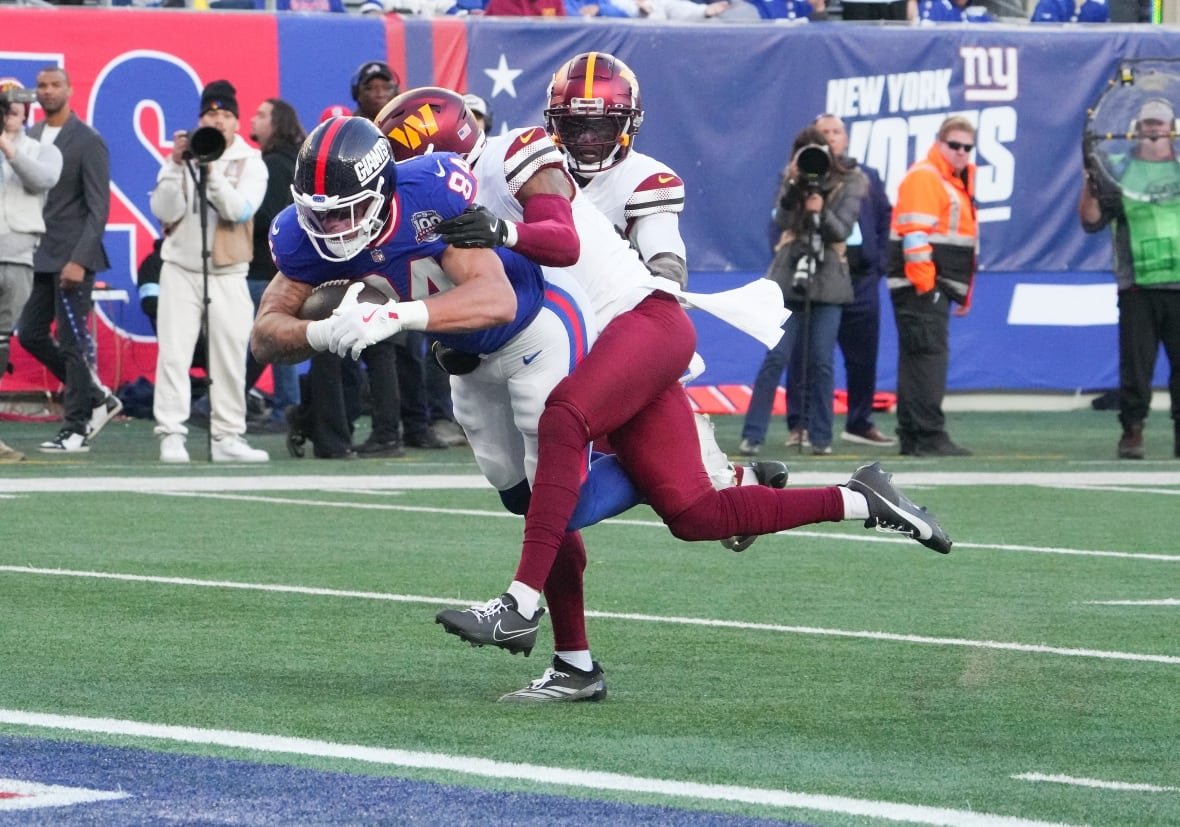 football-nfl Nov 3, 2024; East Rutherford, New Jersey, USA; New York Giants tight end Theo Johnson (84) scores a 4th quarter touchdown against the Washington Commanders at MetLife Stadium. Mandatory Credit: Robert Deutsch-Imagn Images