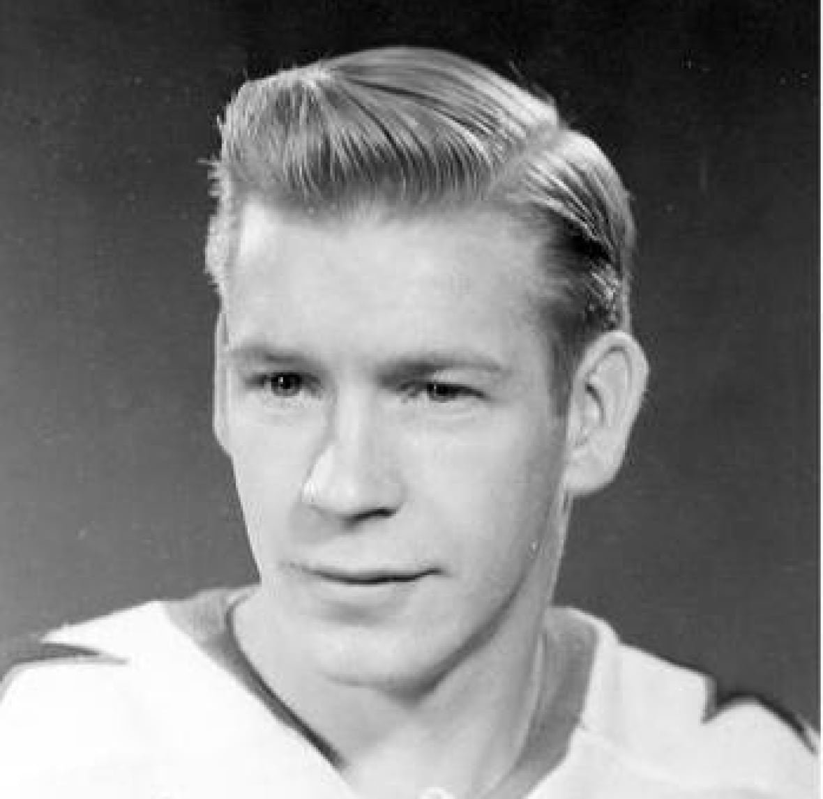 george-faulkner-1 A black and white photo of a man wearing a hockey jersey.