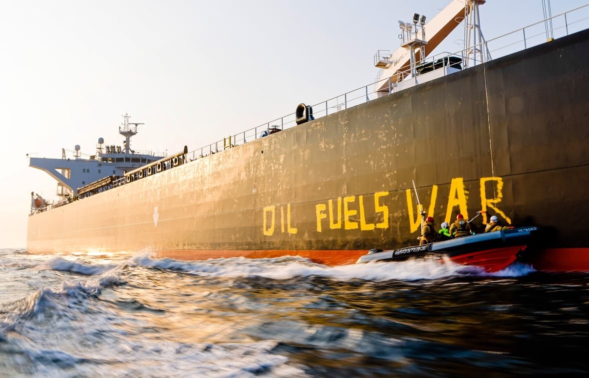 germany-russia-ukraine-war Activists of the environmental organization Greenpeace paint the words 'Oil fuels war' on the hull of a ship carrying Russian oil near the German island Fehmarn, Germany, Wednesday, March 23, 2022.