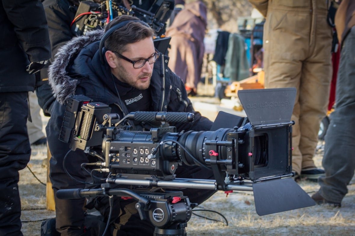 A man operates a film camera