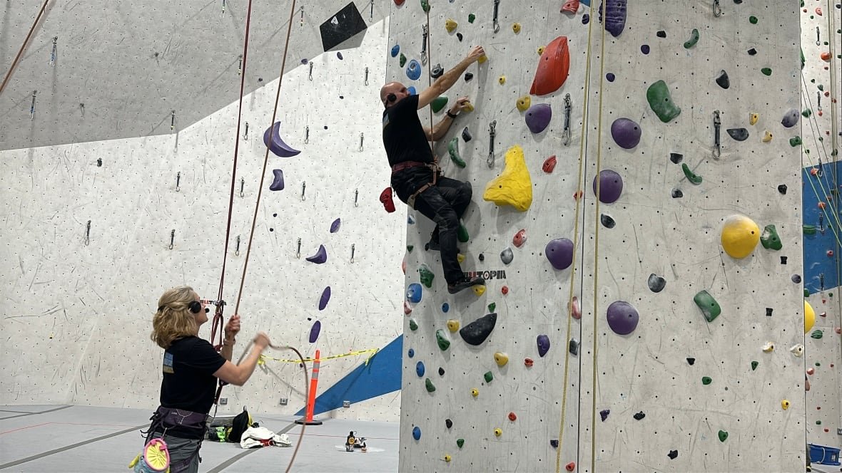 patti-guides-terry The pair communicate with a two-way headset in which Patti guides Terry as he climbs up a wall, telling him how to position his body and grasps.