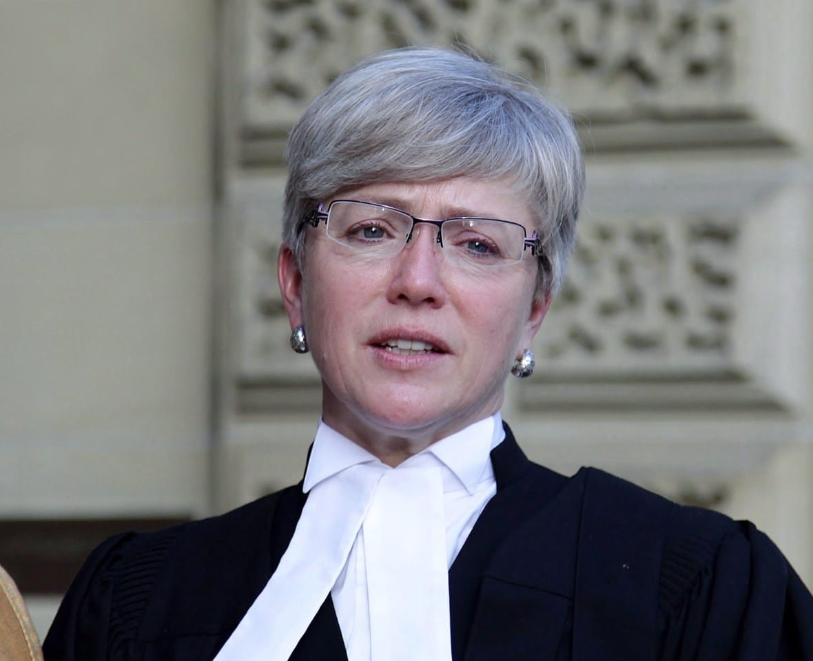 residential-school-fight-20161214 A gowned lawyer stands outside the court.
