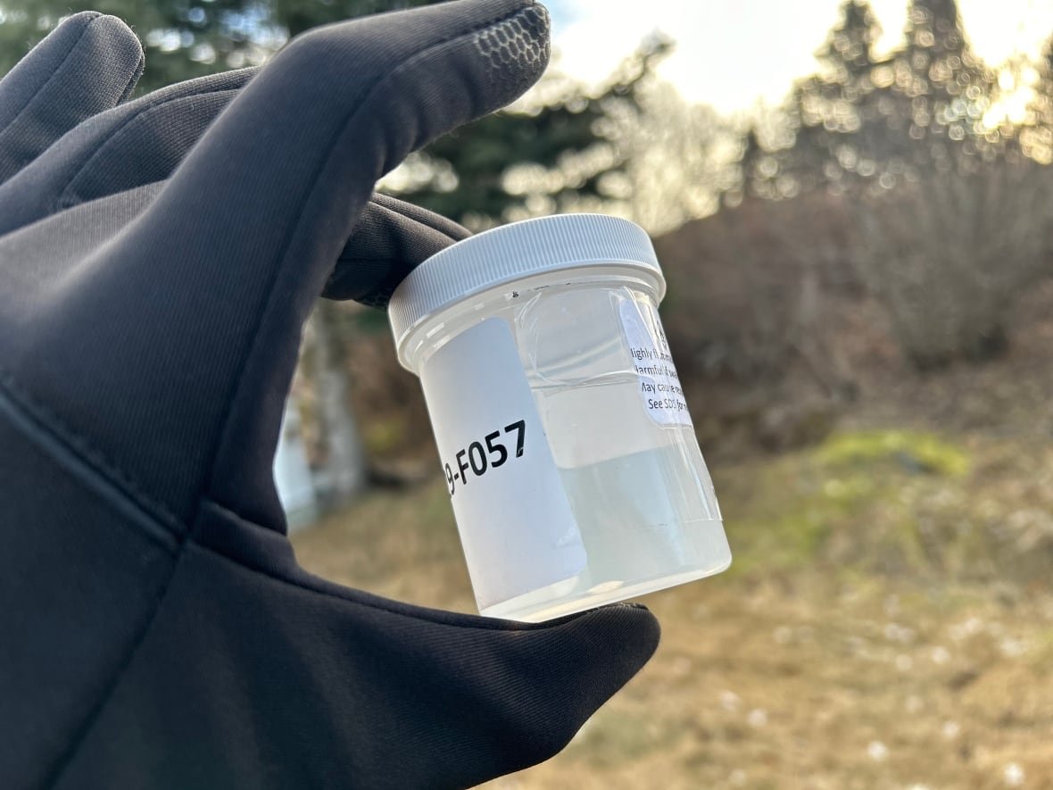 sample-collection-vial A small vial filled with a clear liquid, it has a white lid.