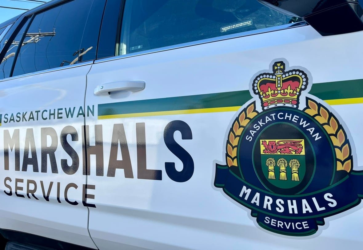 A closeup shows a vehicle with a logo reading "Saskatchewan Marshals Service."