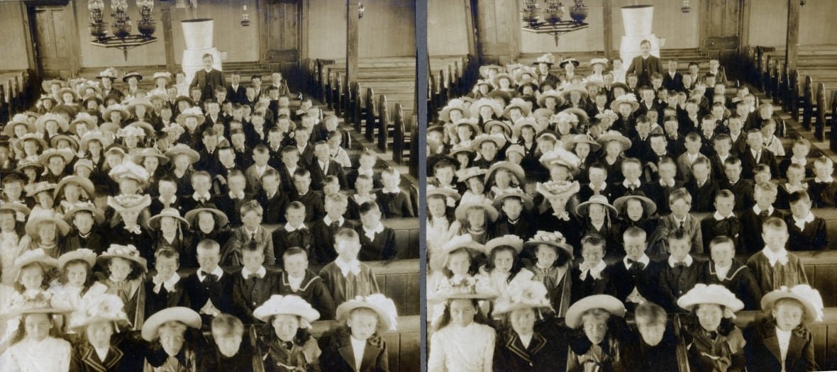 Rows of children sit in church pews.