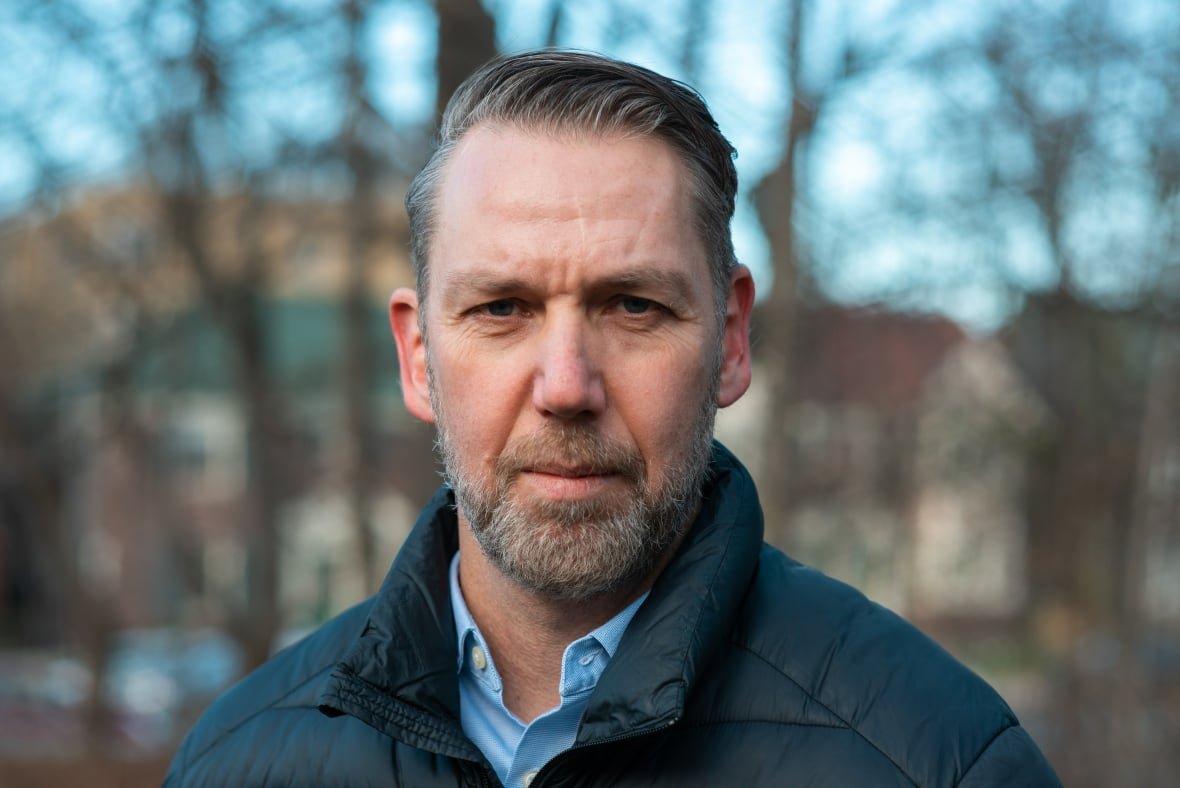A man looks at the camera.