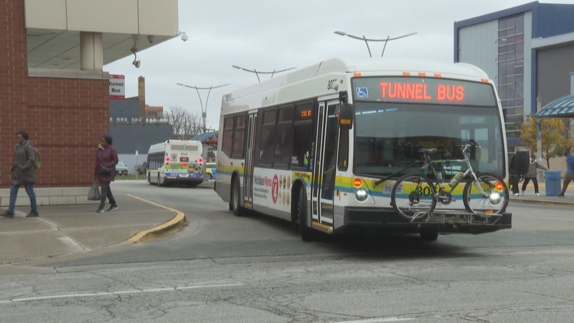 A bus leaves a terminal.