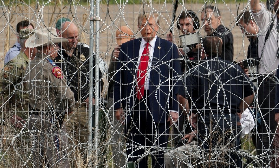 Trump seen through wire fence