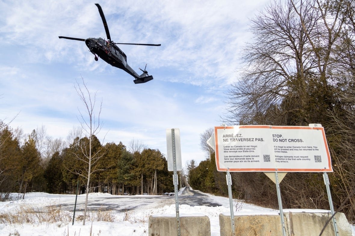 usa-trump-migration-canada An RCMP Blackhawk helicopter patrols at Roxham Road, which has been used as an unofficial crossing point between the U.S. state of New York and the Canadian province of Quebec, along the Canada-U.S. border in Champlain, New York, U.S., January 19, 2025. REUTERS/Carlos Osorio TPX IMAGES OF THE DAY