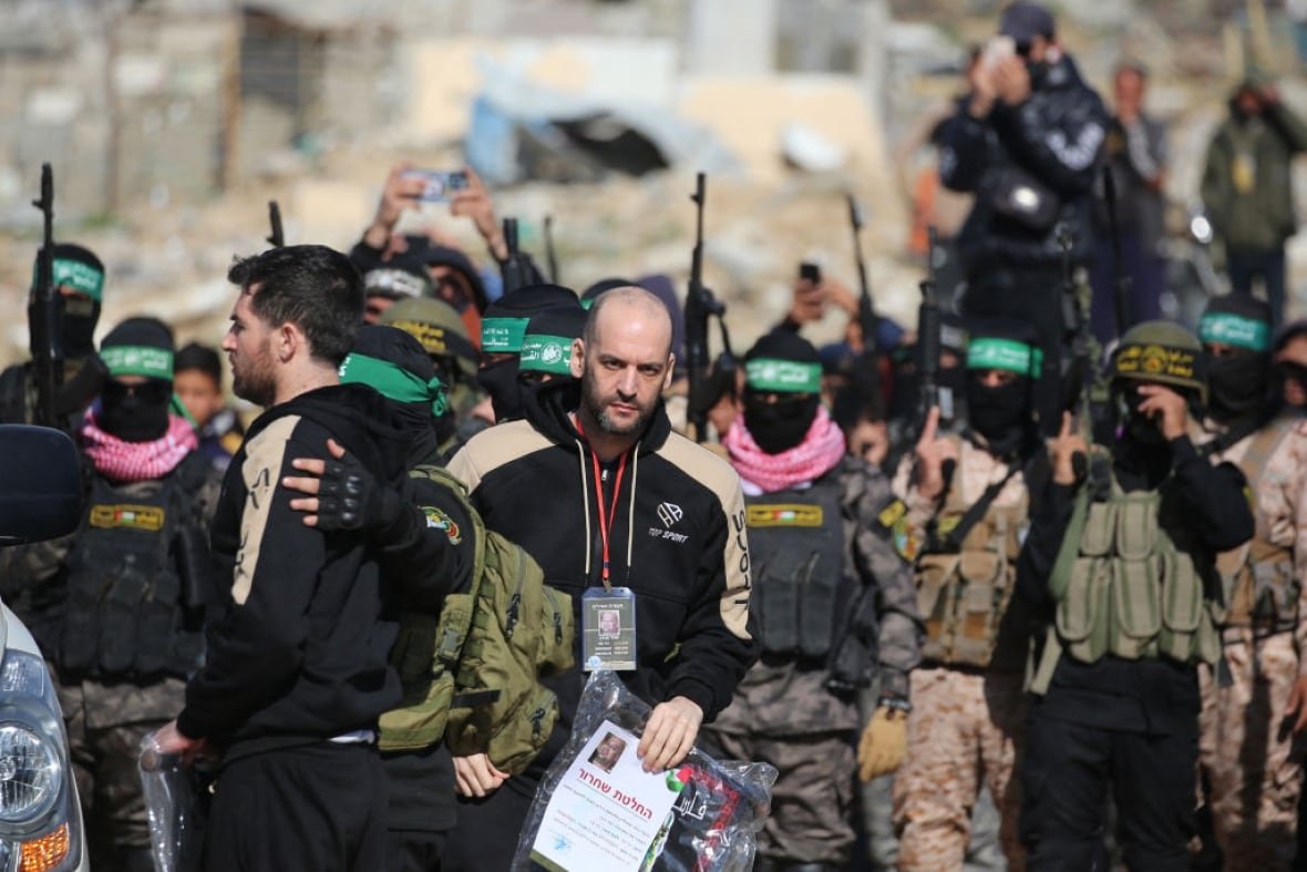 Two Israeli hostages are surrounded by Palestinian militants.