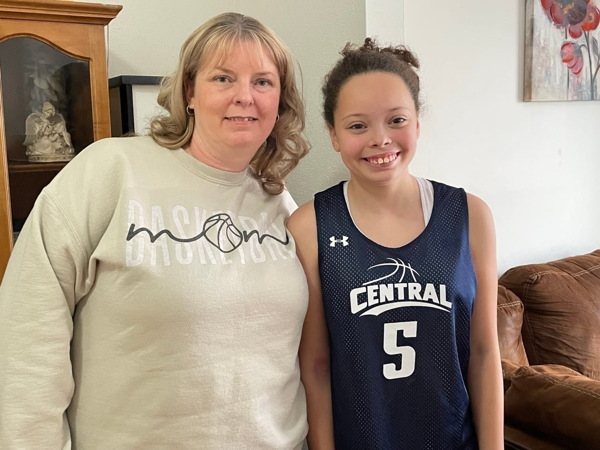 annette-and-kamara-white A smiling mother and daughter. Both are wearing clothing associated with basketball.
