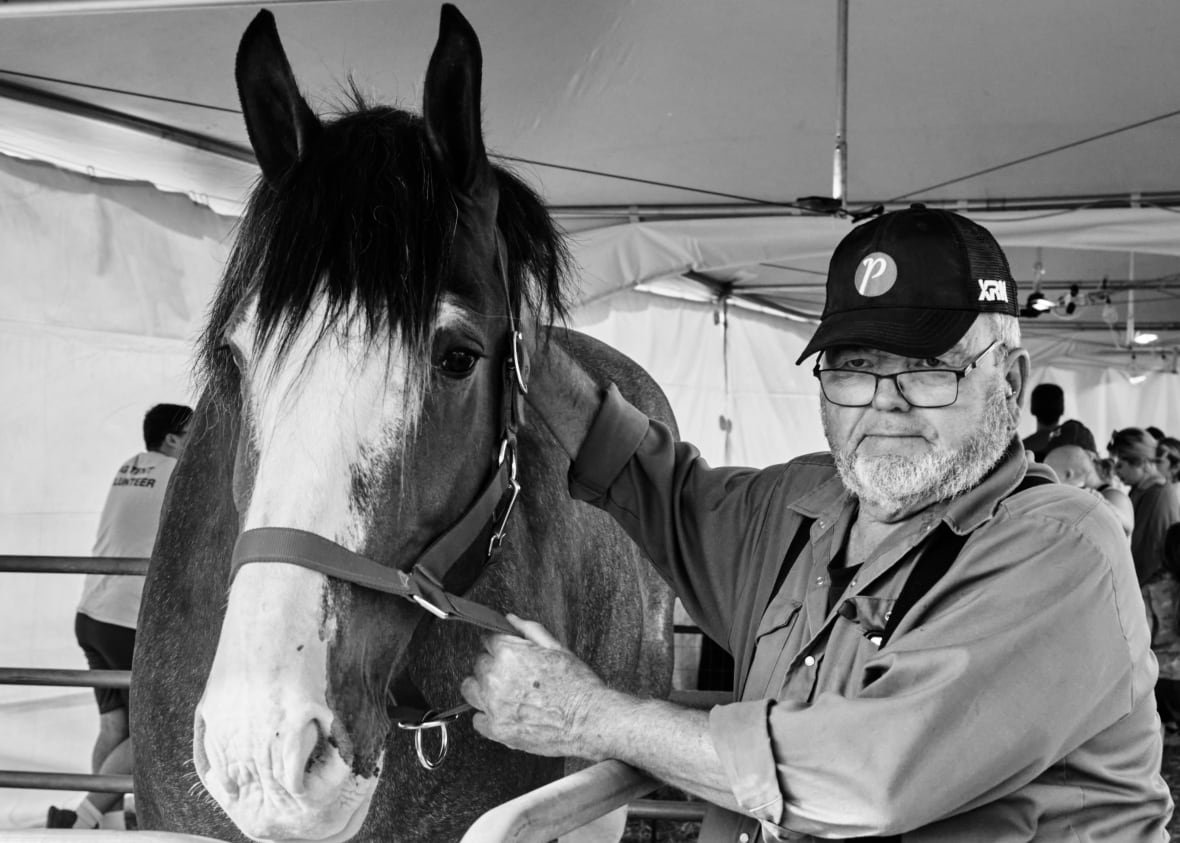 brian-walker A horse and a person stand together stoically