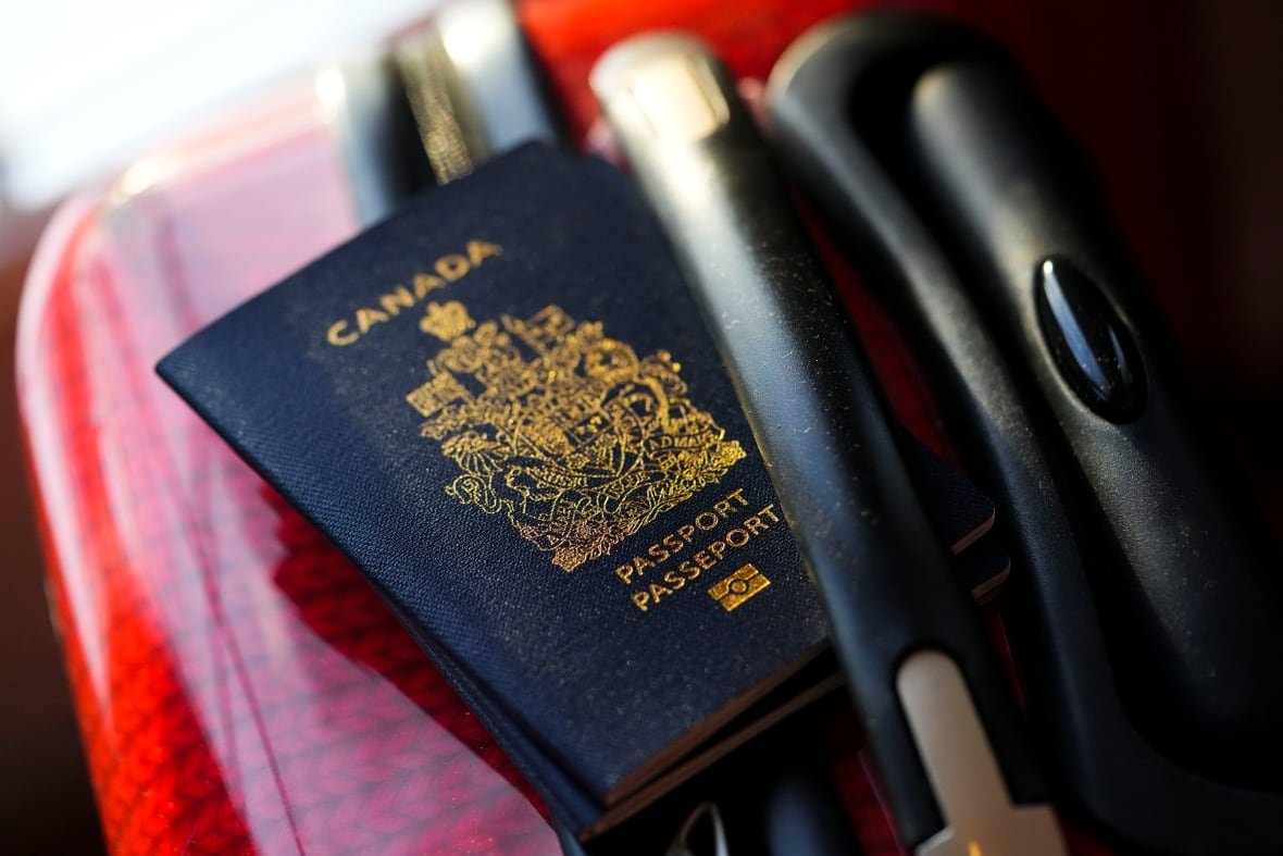 canada-passport-travel-border-1 A Canadian passport on a red suitcase.