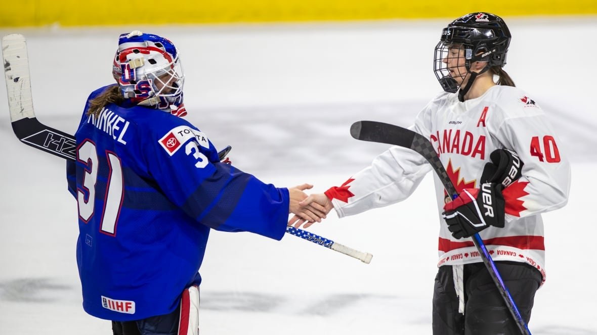 canada-us-hockey-1 An American hockey player and Canadian hockey player shake hands after a game.