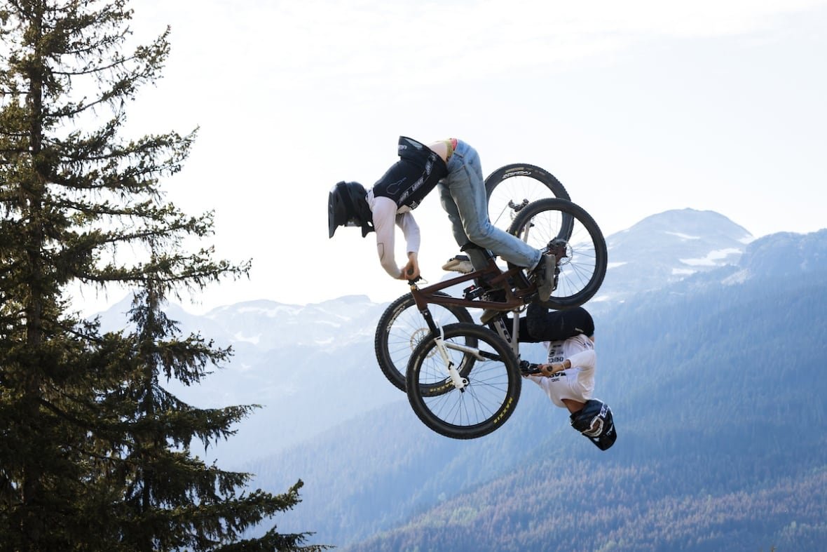 canadian-geographic-3 Two mountain bikers flipping in the air