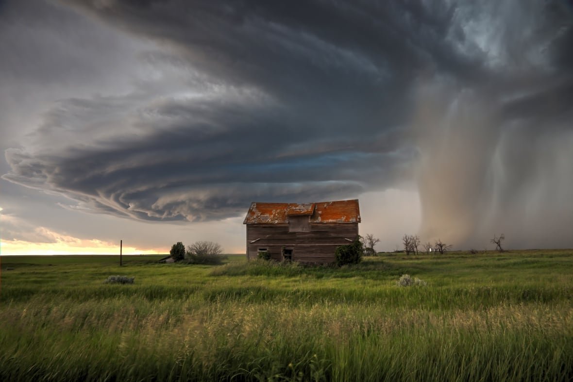 canadian-geographic-6 A tornado-warned storm swirls like a cinnamon bun over a structure in a field