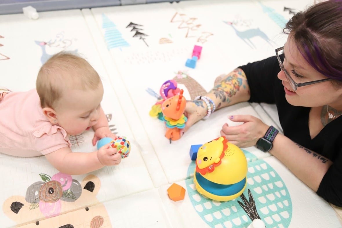 education-teacher-appreciation-child-care A volunteer at Endeavor Elementary's onsite daycare plays with an infant in Nampa, Idaho.