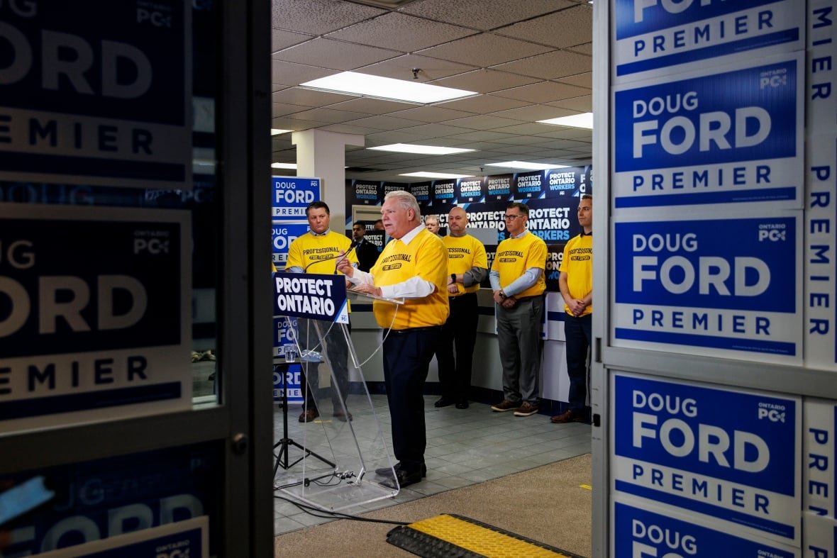ford-tariffs-2 Doug Ford wears a yellow t-shirt, standing at a podium that says 'Protect Ontario."