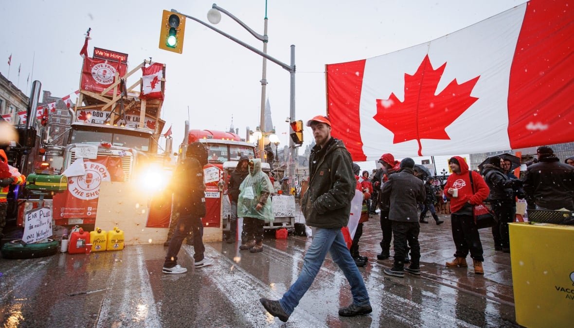 freedom-convoy-ottawa-week-3 A protester walks through an encampment near Parliament Hill, in Ottawa, shortly before being arrested on Feb. 17, 2022.