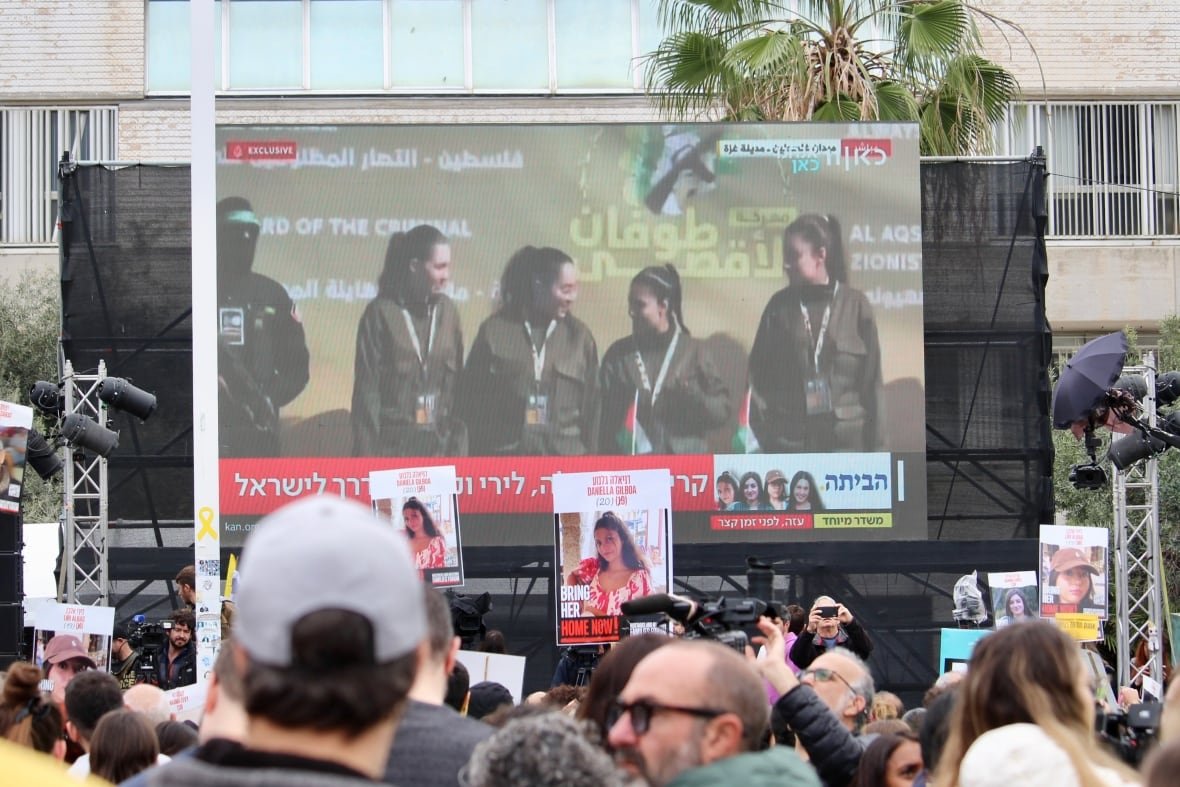 A crowd at hostages square in Tel Aviv watches on a big screen as four women soldiers are returned from captivity in Gaza on Feb 25, 2025