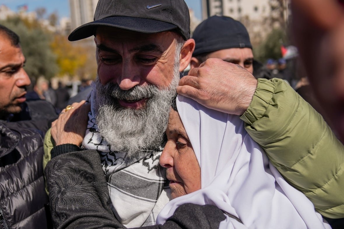 Two people embrace.