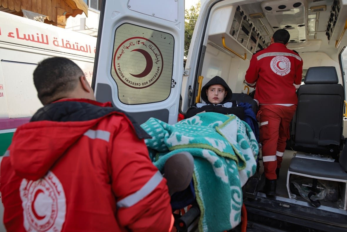 israel-palestinians-5 A girl is carried into an ambulance.