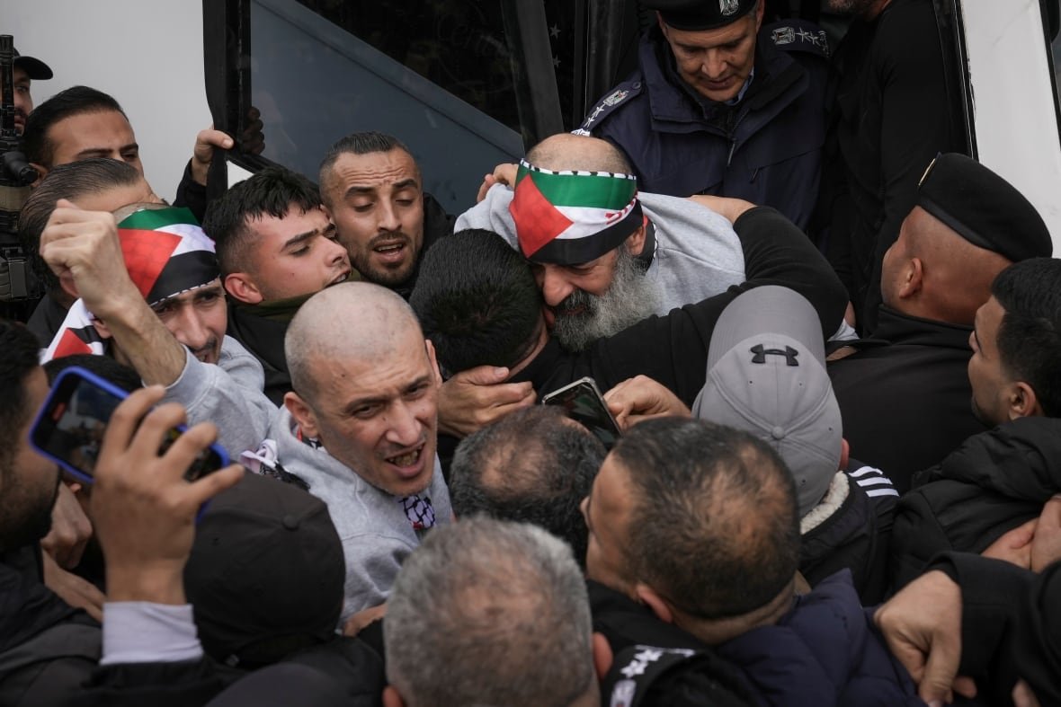 israel-palestinians-6 A group of men cheer and embrace or greet each other.