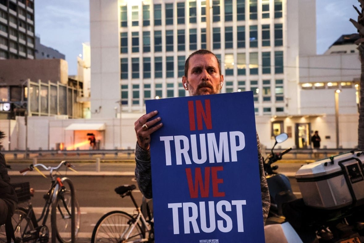 A protester holds a placard demanding the return of all hostages held in Gaza since the deadly October 7 2023 attack by Hamas, ahead of a planned meeting between U.S. President Donald Trump and Israeli Prime Minister Benjamin Netanyahu, outside the U.S. Consulate in Tel Aviv, Israel February 3, 2025.