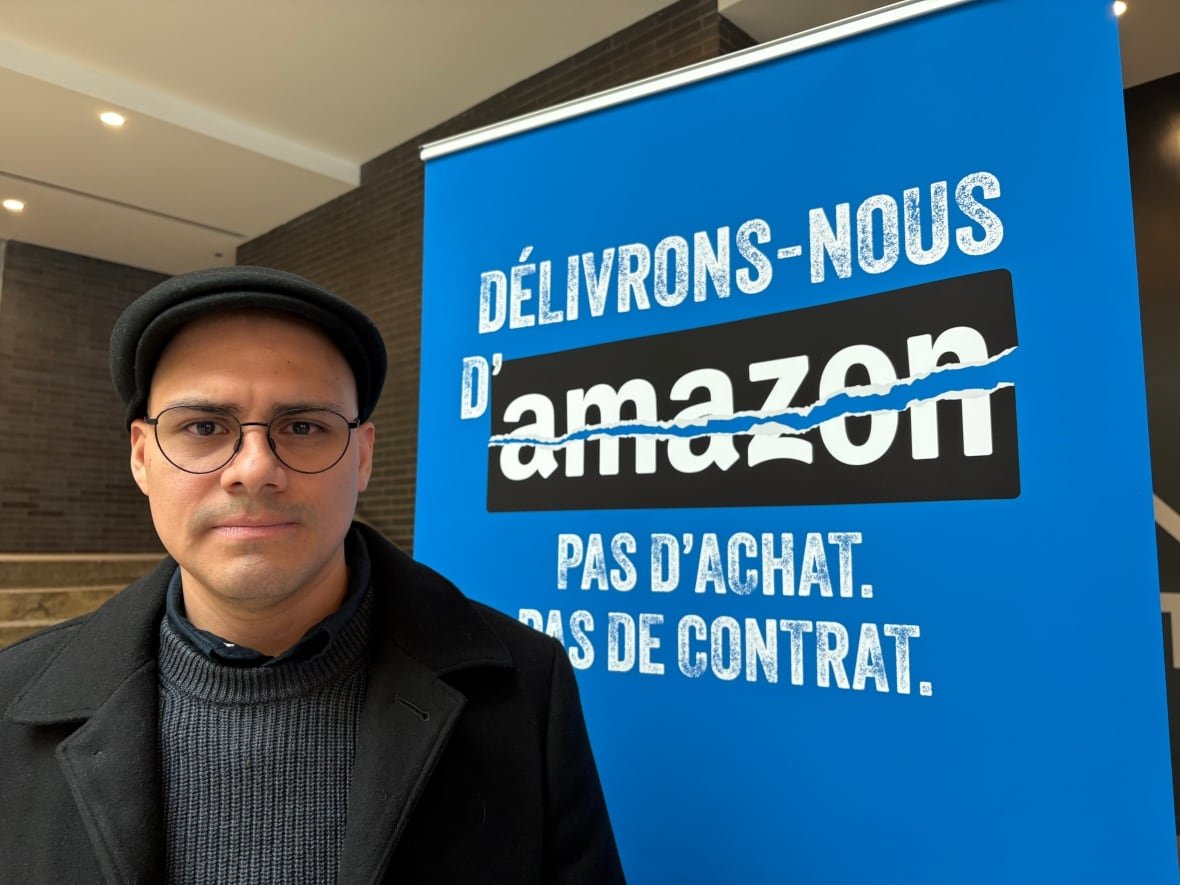 michael-cordova man with sign denouncing amazon