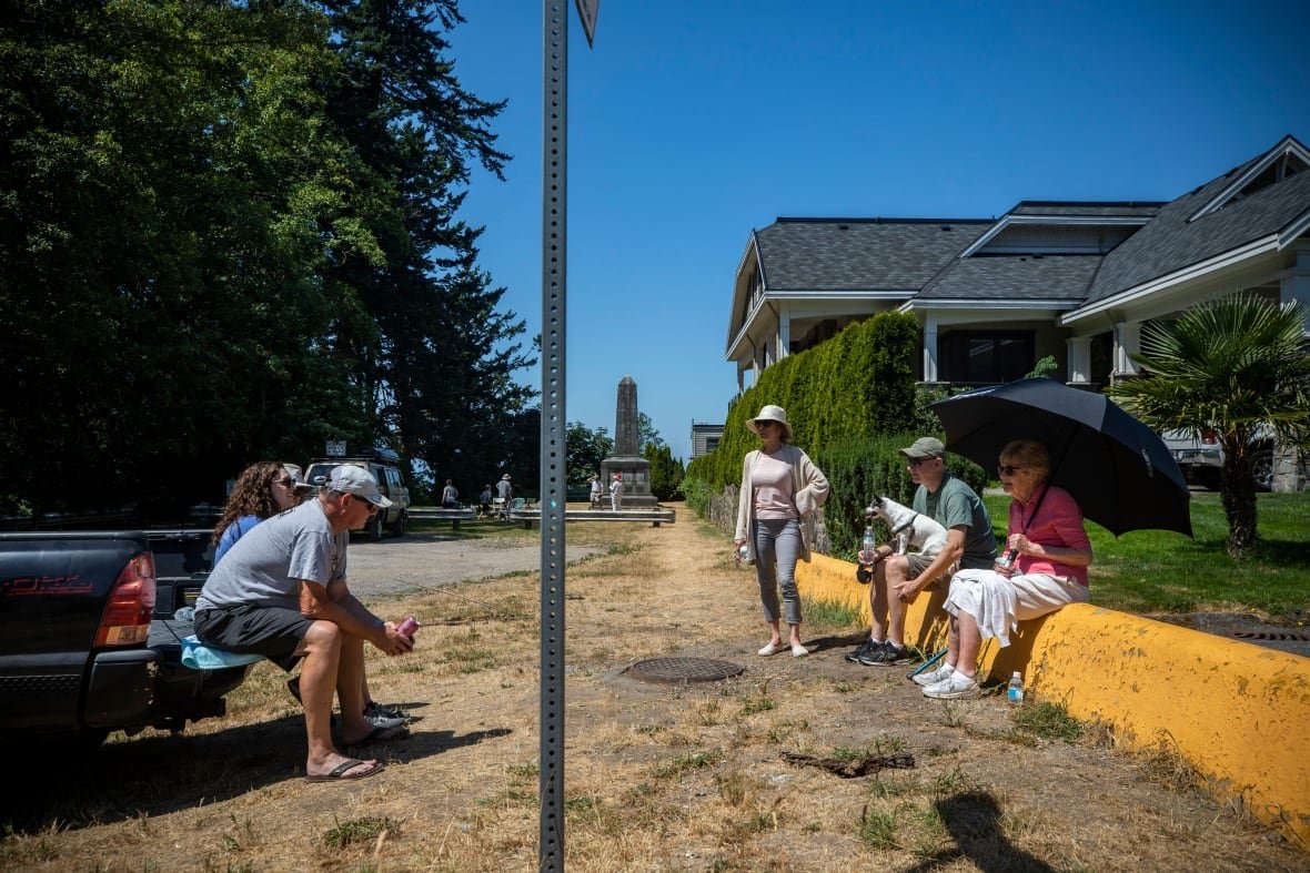 point-roberts-1 people sit on either side of a sign