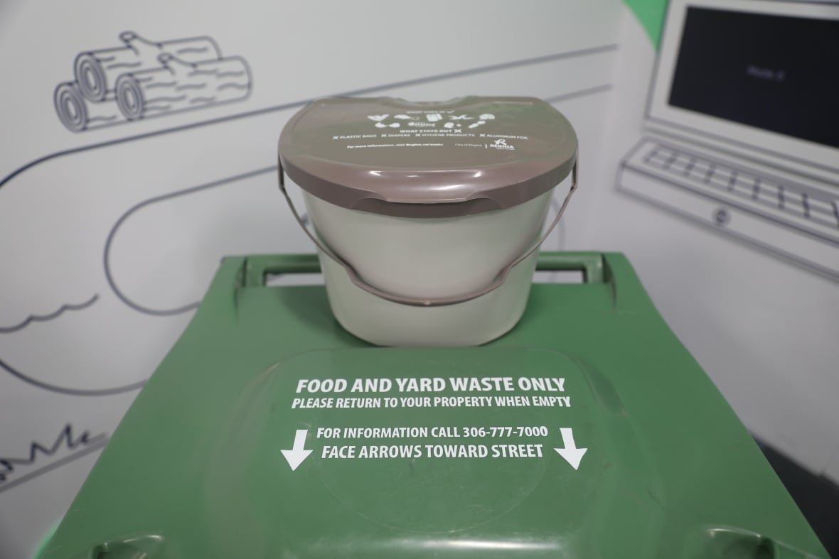 regina-green-bin-green-cart-organic-waste-compost A kitchen catcher bucket sits on top of a green cart used to dispose of yard and food waste in Regina.