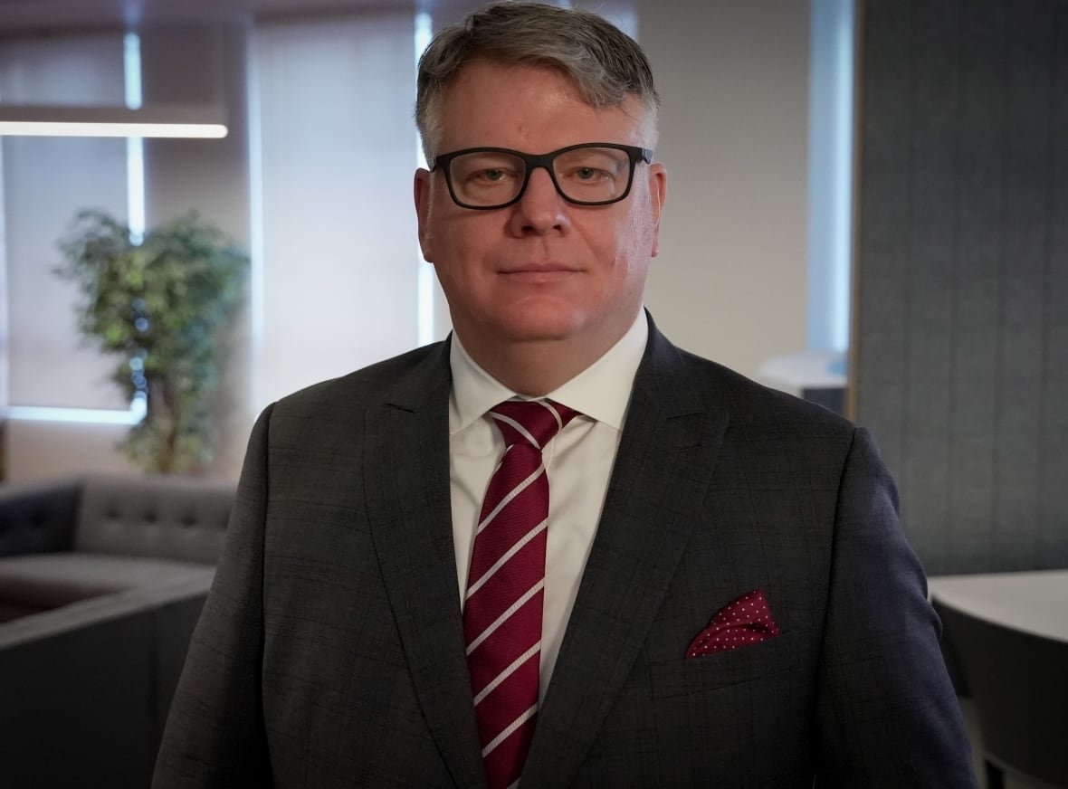 Retired lieutenant-colonel Rory Fowler, a former military lawyer now in private practice poses for a photo in an office.