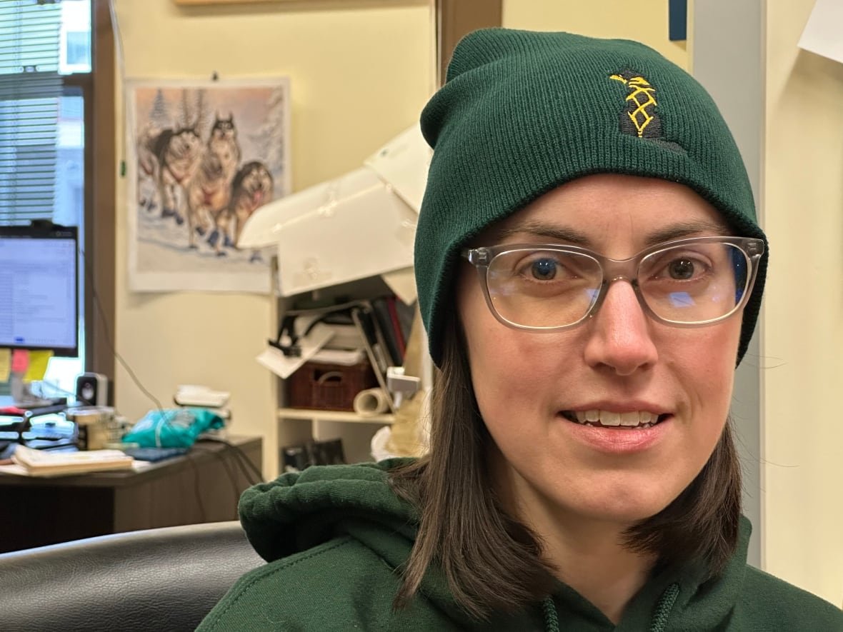 sarah-tomlin Close up of a young woman in a toque and glasses.