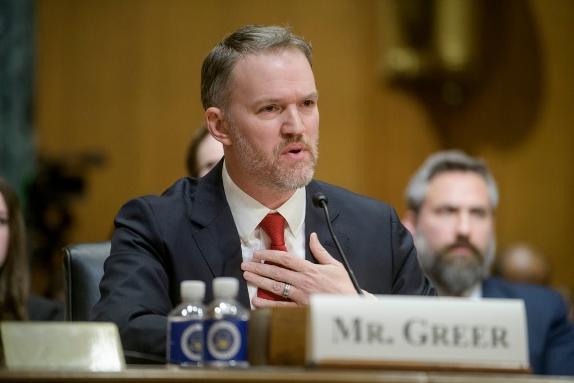 Man in suit at committee table