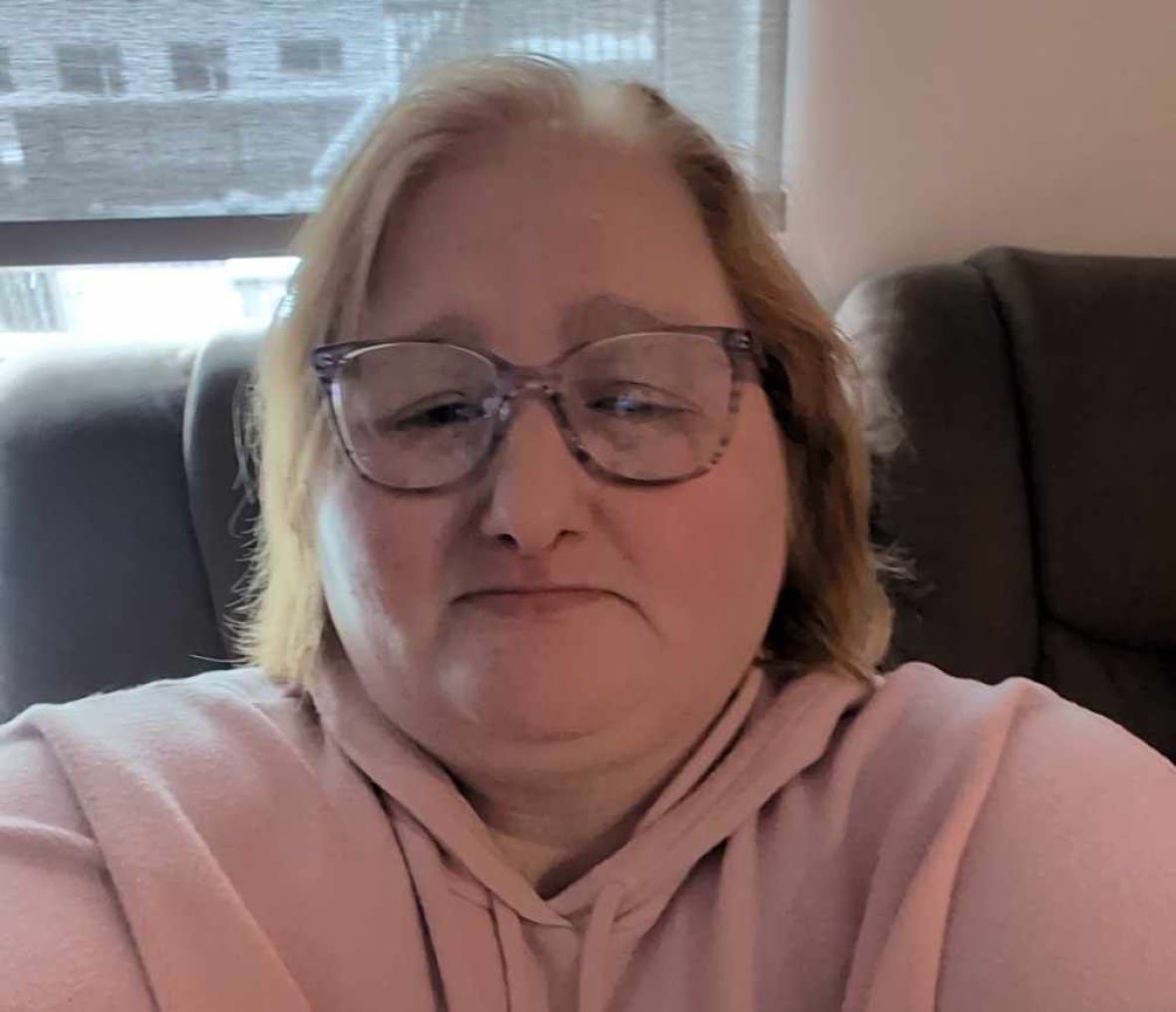 shawna-morgan-1 A selfie of a woman wearing glasses and a pink hoodie.