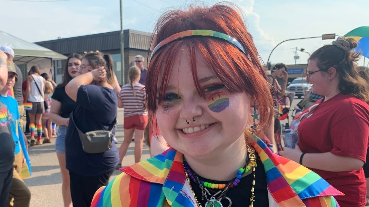 shaylin-lussier Wearing a rainbow jacket with rainbows painted on her cheeks, Shaylin Lussier stands in front of a crowd of people in her hometown of Westlock, Alberta.