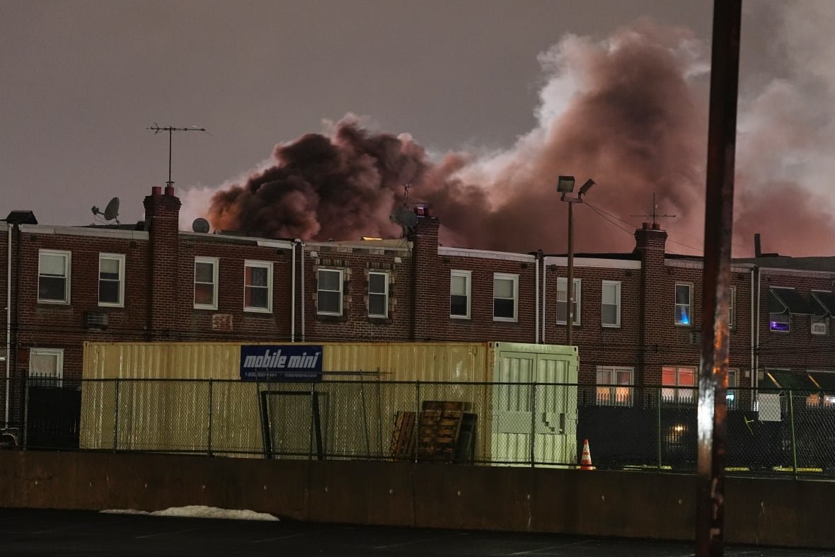 smoke-rising-above-a-set-of-philadelphia-row-houses Smoke rises above a set of row houses in Philadelphia in the aftermath of a plane crash.