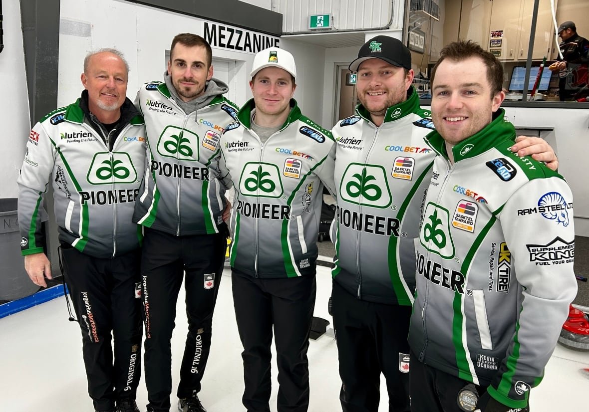 team-sask-brier Five men in curling jerseys pose for a photo.