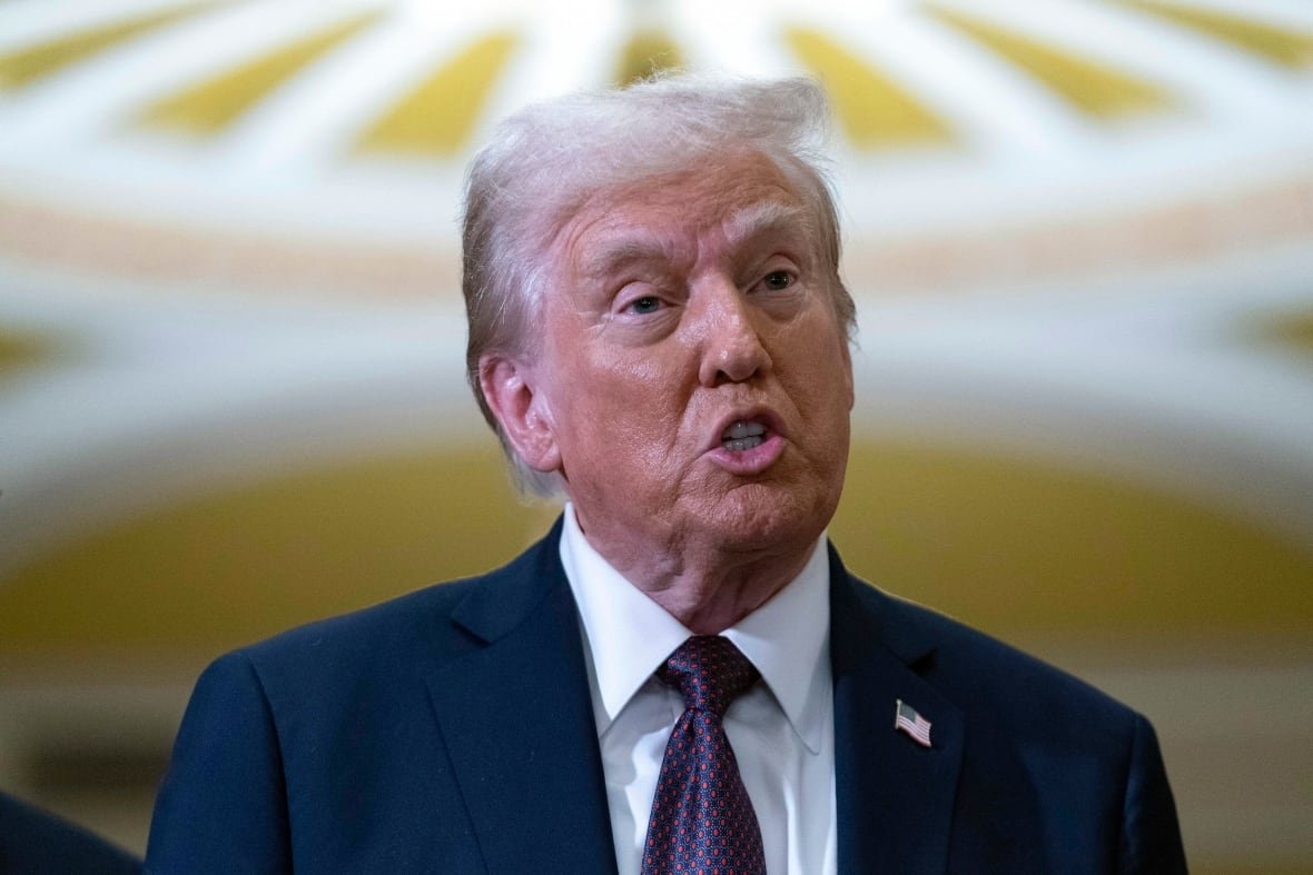trump-15 U.S. President Donald Trump wears a navy suit, white dress shirt, and navy and red tie.
