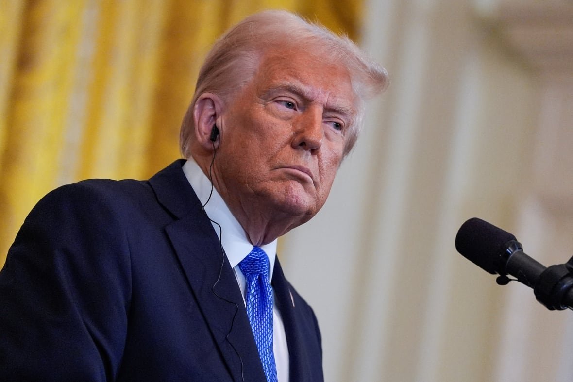 U.S. President Donald Trump, wearing an earpiece, during a news conference.