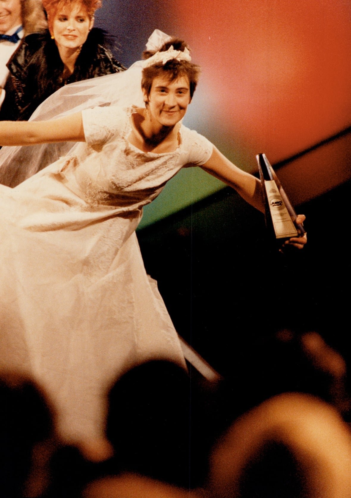 K.d. lang on stage wearing a wedding gown and long veil.