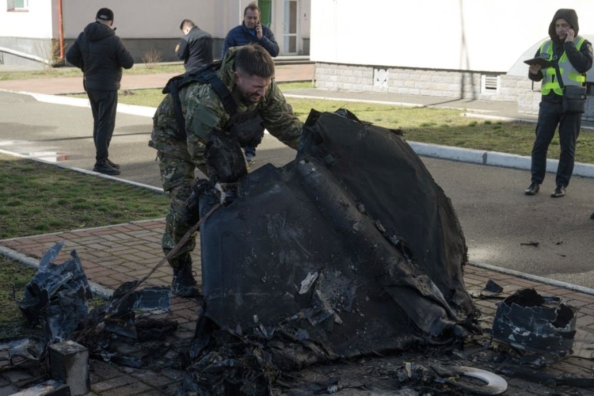 a-man-holds-up-a-portion-of-a-downed-drone-in-kyiv-ukraine A man holds up a portion of a downed drone in Kyiv, Ukraine.