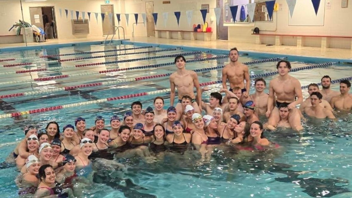 acadia-swim-team a group of people in an indoor pool